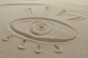A drawing of an eye in sand to describe the feeling of having dry eyes