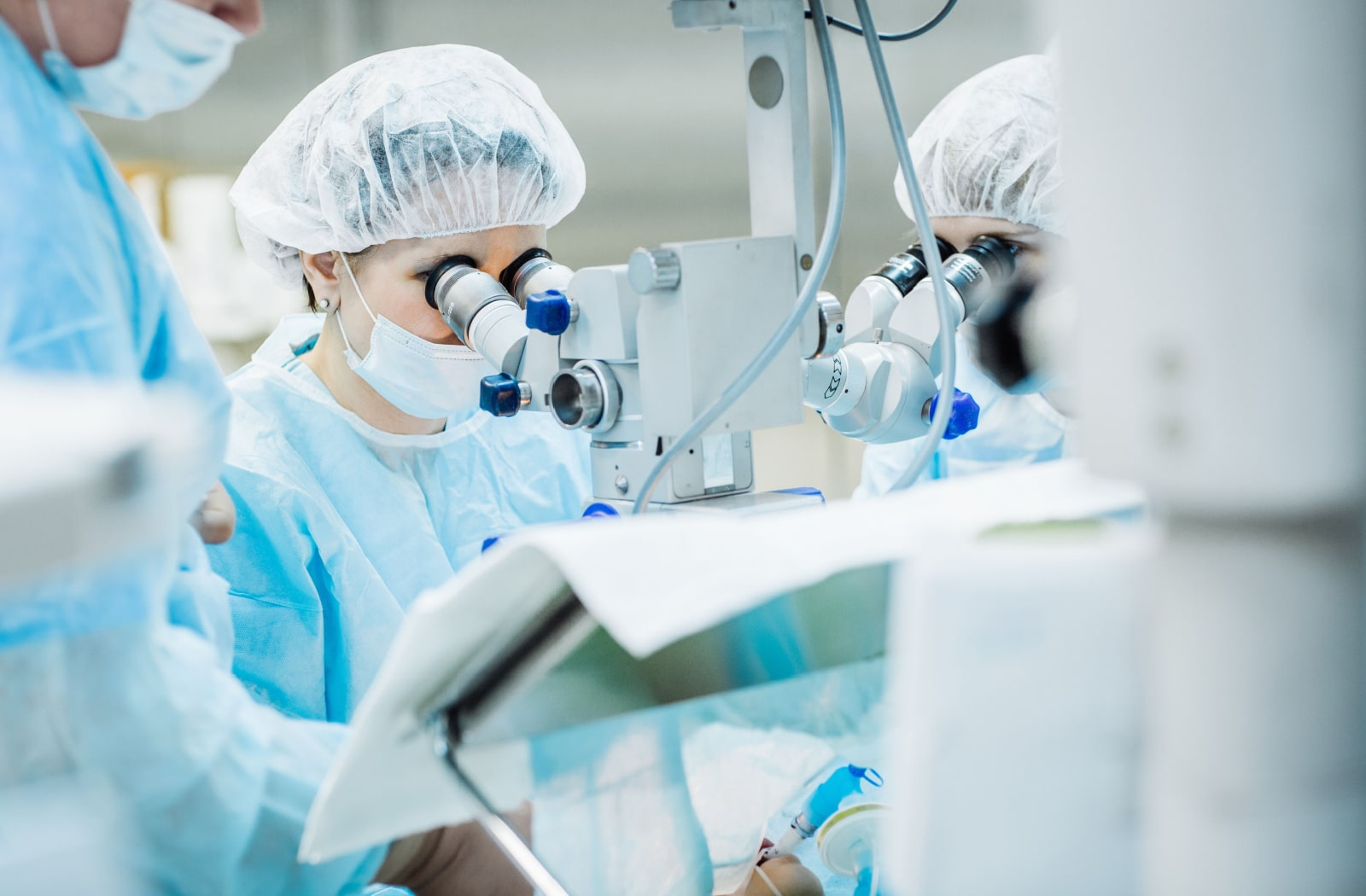 A female ophthalmic surgeon performing cataract removal surgery on a patient.