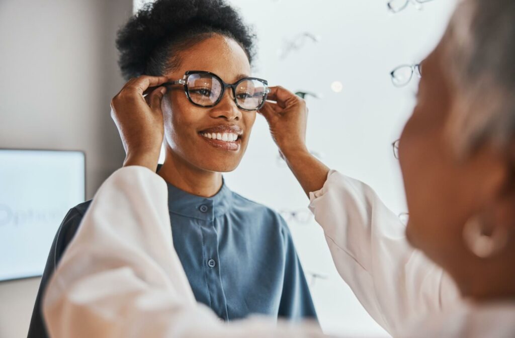 A woman is getting a new pair of eye glasses from her optometrist.